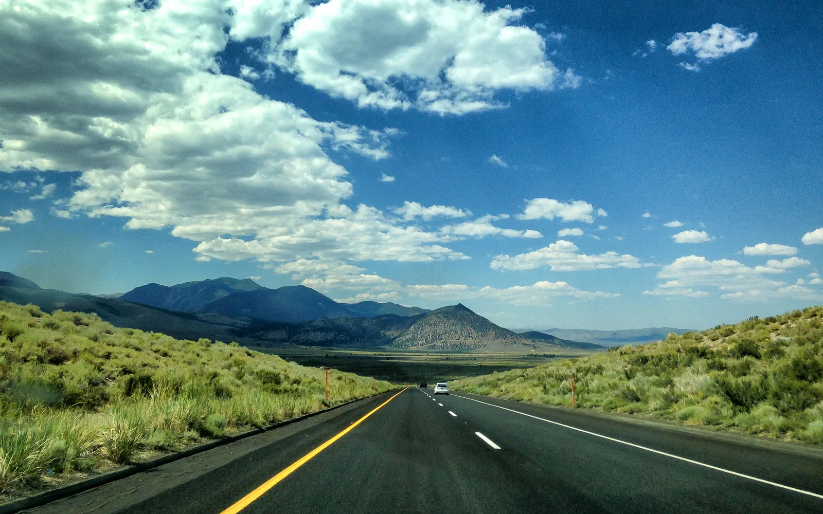 Sierra Nevada mountains rising above golden grassland in Eastern California, photographed from U.S. Route 395
